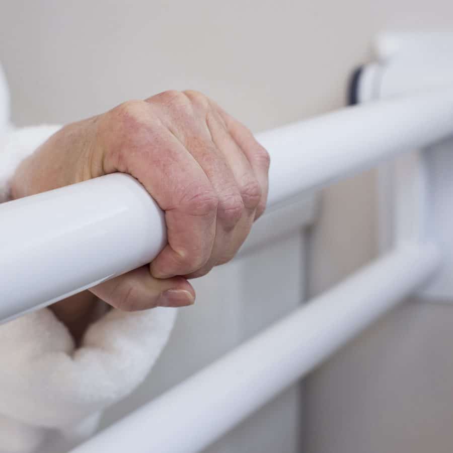 a hand reaching out holding onto a PT Rail