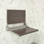 The SerenaSeat Pro installed in a shower - Seat is Brushed Stainless Steel frame and Medium Bamboo wood finish
