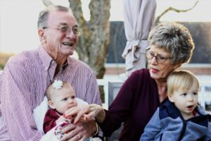 Grand-parents holding their young grandkids