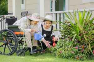 Photo of a woman gardening with her mother who is in a wheelchair.