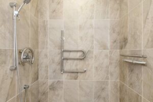 Shower design with multiple grab bars to choose from. Crescent Ring, DependaBar, and the Shampoo shelf