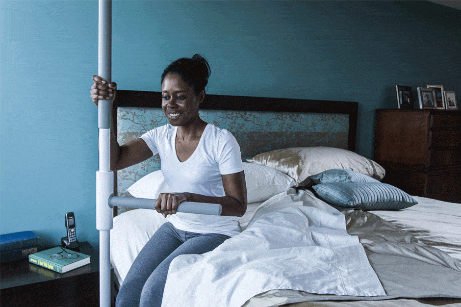 woman using the superpole to get out of bed