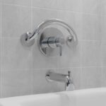 chrome plus crescent ring above a shower/bath faucet