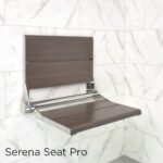 Medium wood SerenaSeat Pro on a white marble tile wall