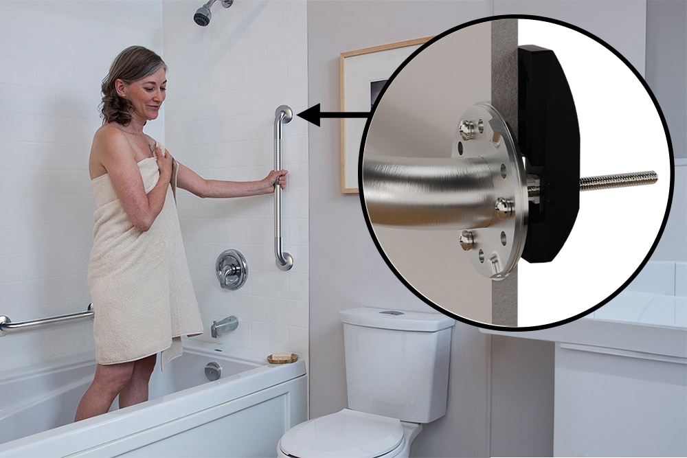 A woman holding a grab bar. A cutout shows that the grab bar is installed with a EasyMount Hollow Wall Anchor.