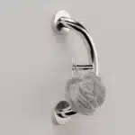 PLUS towel hook and grab bar with a luffa hanging from its hook.